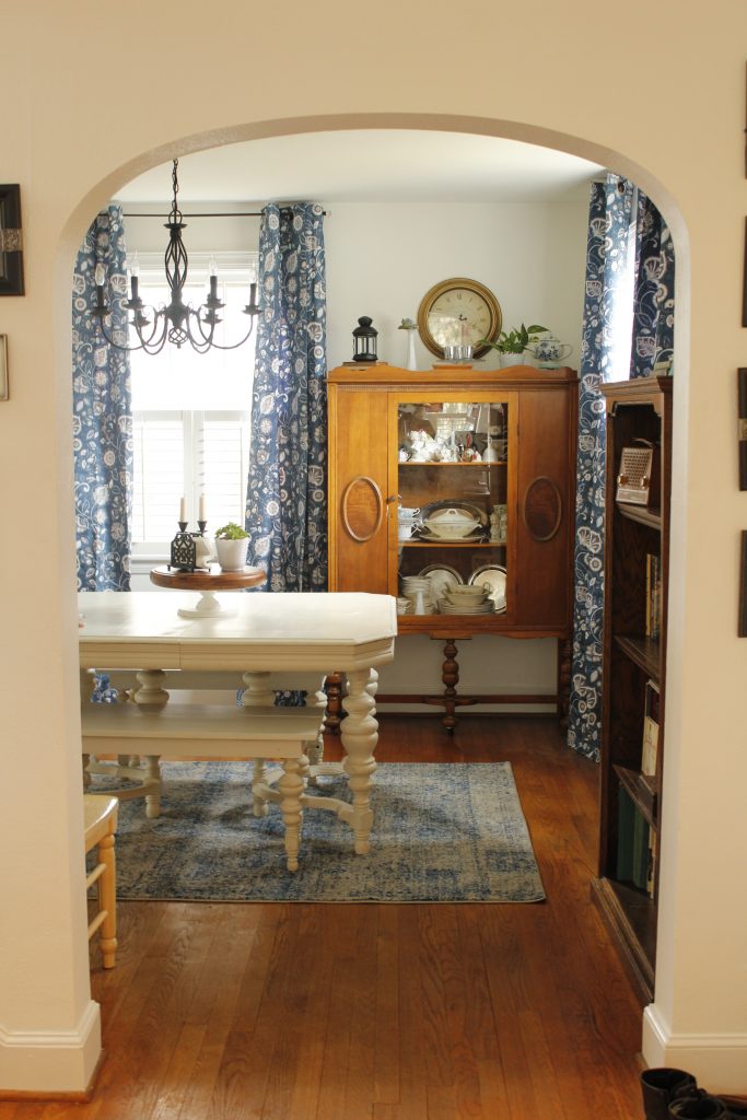 Showing the dining room with the updated blue curtains and rug