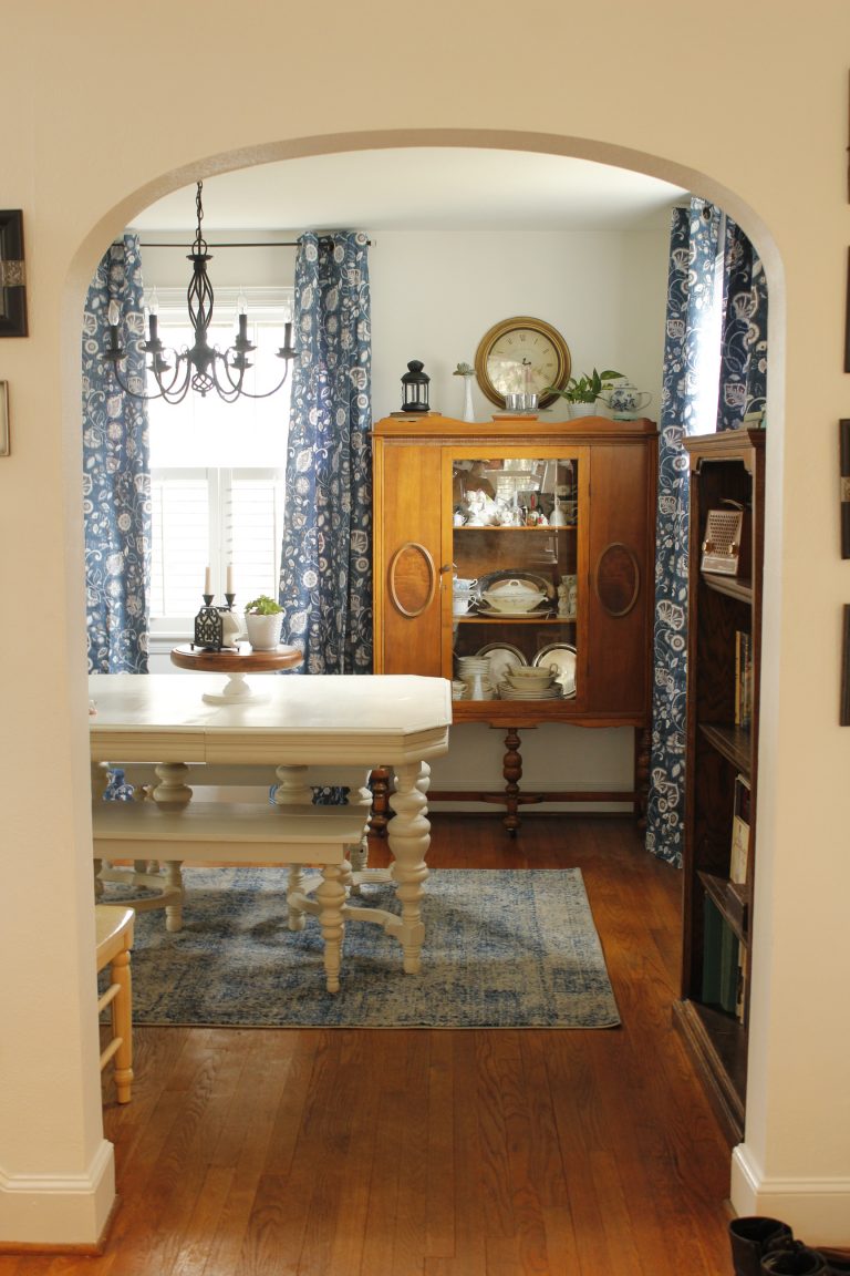 The dining room with the updated blue curtains and rug